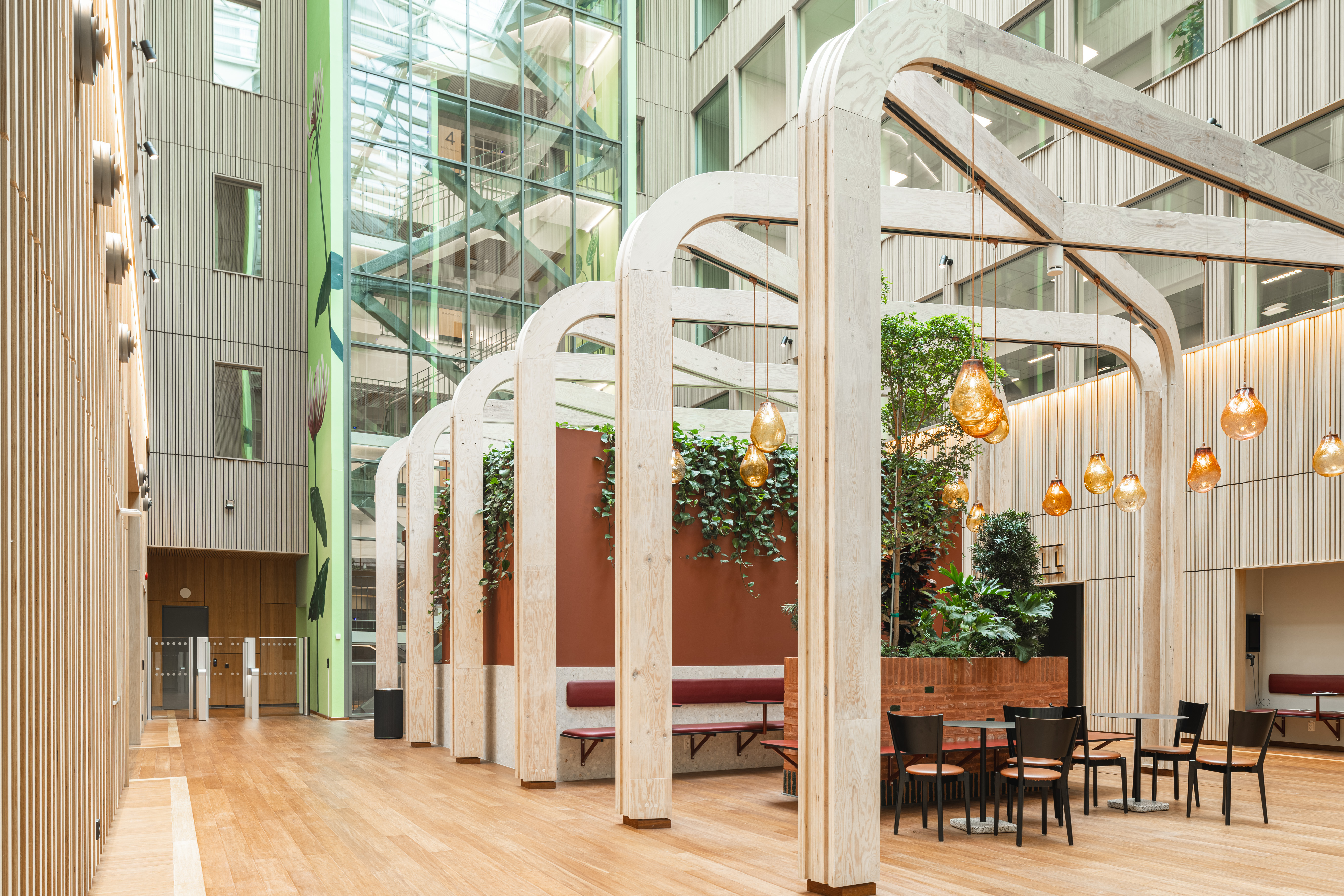 Mörkhårig kvinna i grön tröja sitter framför en dator.